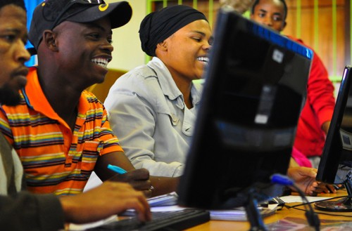 People smiling at a computer