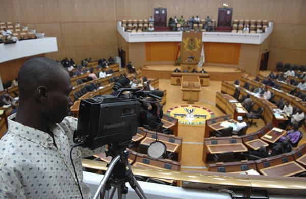A man filming a parliamentary session