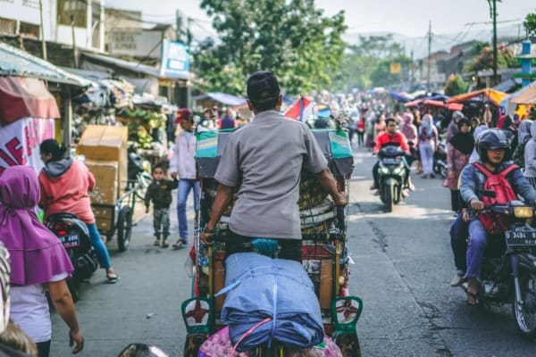 Busy streets in Indonesia, navigating barriers and obstacles.