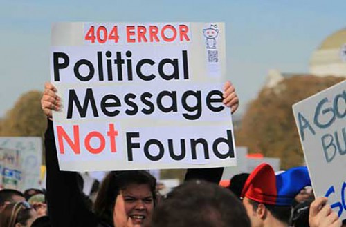 Person holding sign reading 