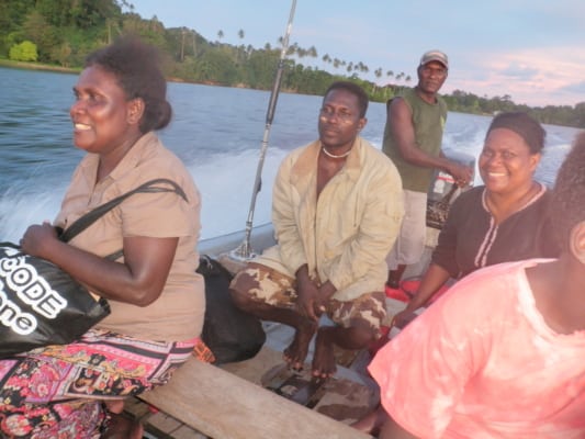 Esther Suti sitting at the front of a boat with the PLP team