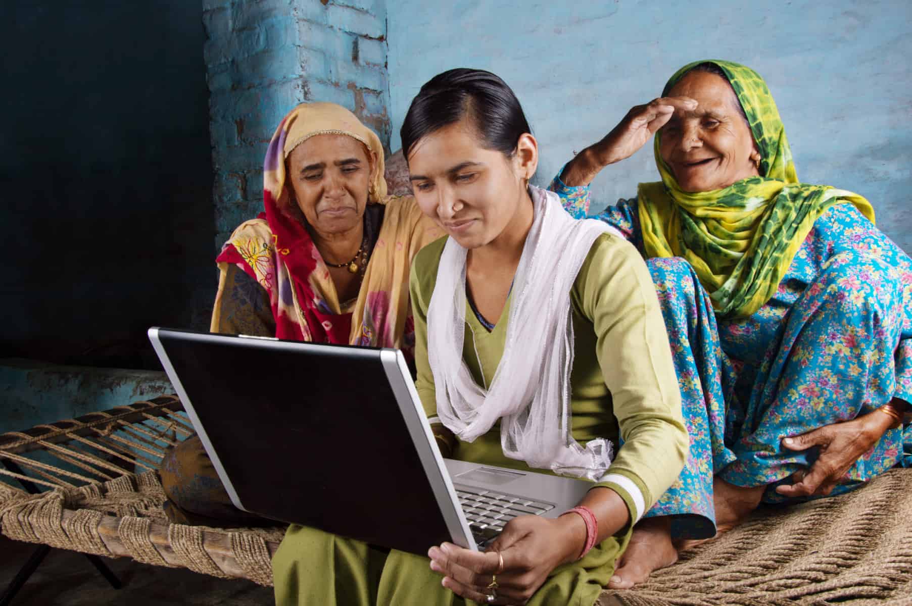 Three women looking at a laptop