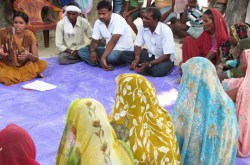 Men and women sitting in a circle