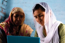 Two women looking at a laptop