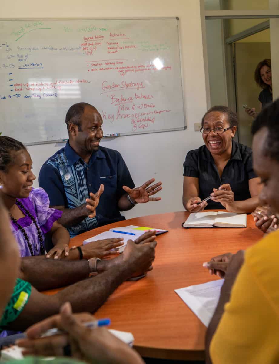 A group of people laughing around a table