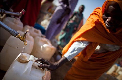 Woman using a water tap