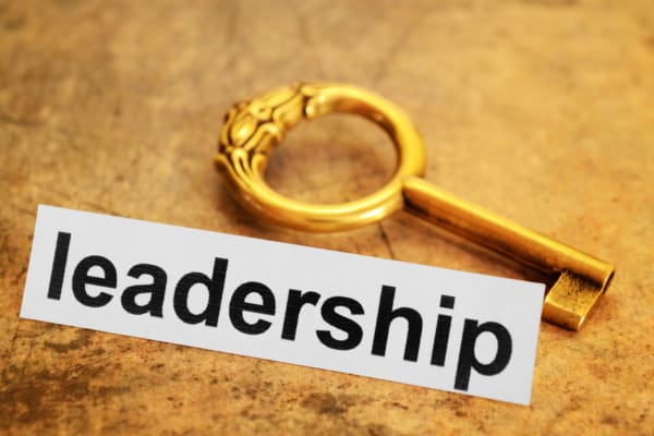 A golden key beside the word 'leadership'