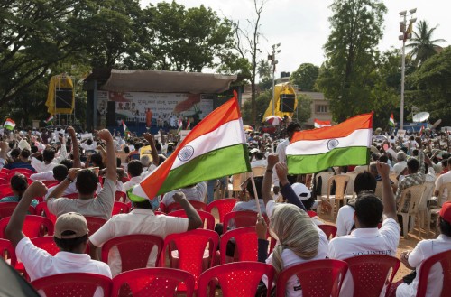 A seated crowd waving flags