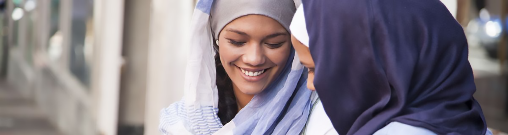 Two women smiling at each other