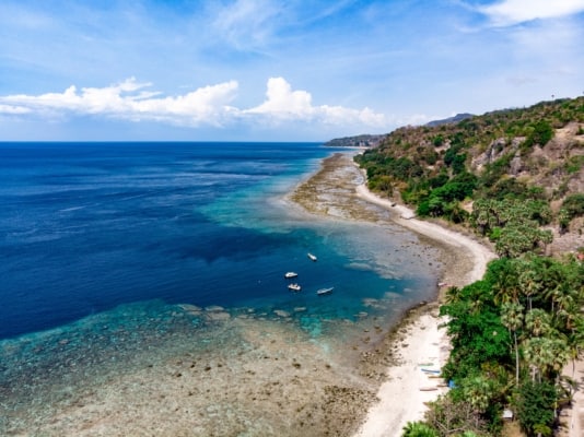coastline with beach, sea, sky and boats, Timor-Leste